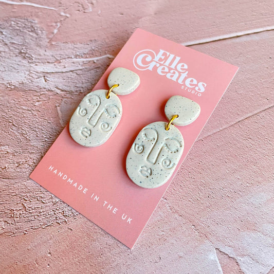 SMALL SPECKLED WHITE BLUSHING FACE STATEMENT EARRINGS